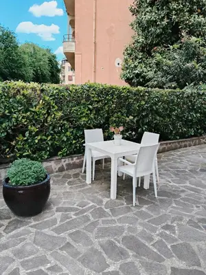 a white table and two chairs on a stone patio at Appartament Piramide Cestia in Rome