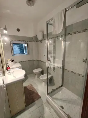 a bathroom with a shower and a sink and a toilet at Appartament Piramide Cestia in Rome