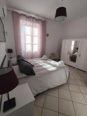 a bedroom with a large bed and a window at Appartament Piramide Cestia in Rome