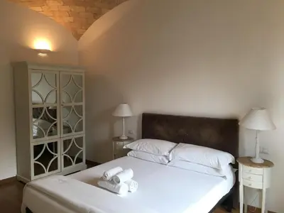 a bedroom with a bed with two white towels at La finestra sul Colosseo B&B 1 in Rome
