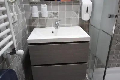 a bathroom with a white sink and a toilet at Quest House Lihong in Rome