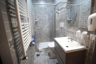 a bathroom with a sink and a toilet and a shower at Quest House Lihong in Rome