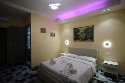 a bedroom with a bed with a purple lighting at Quest House Lihong in Rome