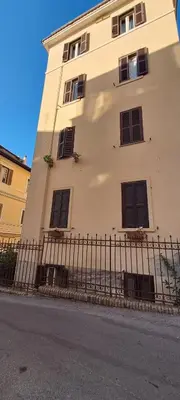 a building with windows and a fence next to a street at Saint Peter s roof in Rome