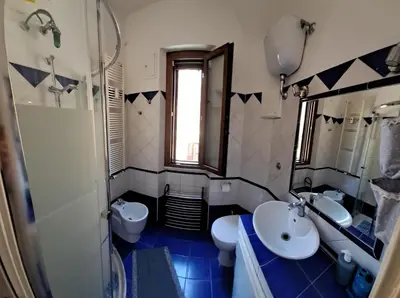 a bathroom with two sinks and a toilet and a mirror at Saint Peter s roof in Rome
