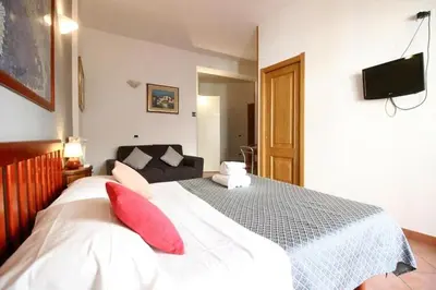 a bedroom with a large white bed with red pillows at Holiday flat in central location in Rome in Rome