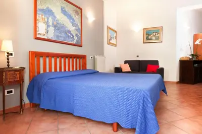 a bedroom with a blue bed and two chairs at Holiday flat in central location in Rome in Rome