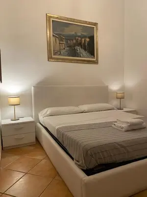 a bedroom with a bed and a painting on the wall at mini Apartment in Rome
