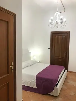 a bedroom with a bed and a chandelier at mini Apartment in Rome