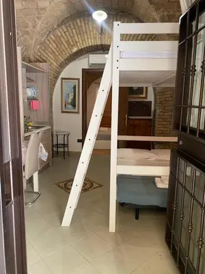 a room with a bunk bed with a ladder at mini Apartment in Rome