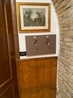 a picture of a painting on a wall next to a door at mini Apartment in Rome