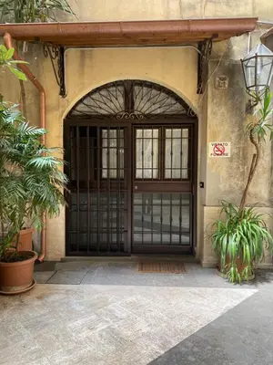 an entrance to a building with a black door at mini Apartment in Rome