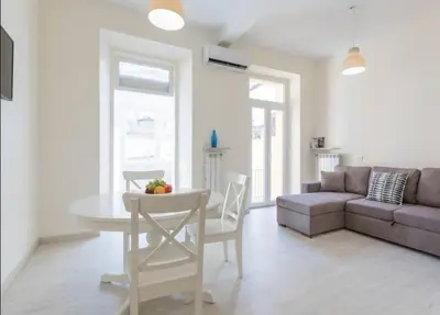 a living room with a table and a couch at Quiet with large terrace in Spanish Steps area in Rome