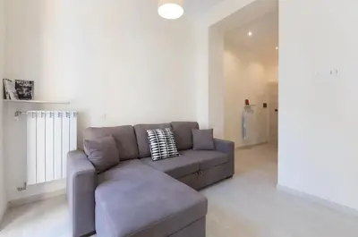 a living room with a gray couch in a room at Quiet with large terrace in Spanish Steps area in Rome