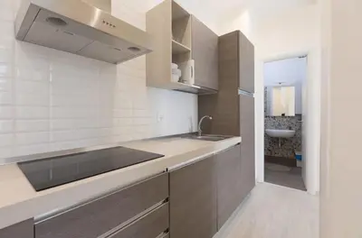 a kitchen with a sink and a counter top at Quiet with large terrace in Spanish Steps area in Rome