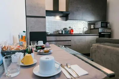 a kitchen with a table with plates of food on it at Angelina Apartment Roma Monteverde in Rome