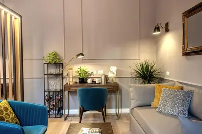 a living room with a couch and a table at Tree Charme Parliament Boutique Hotel in Rome