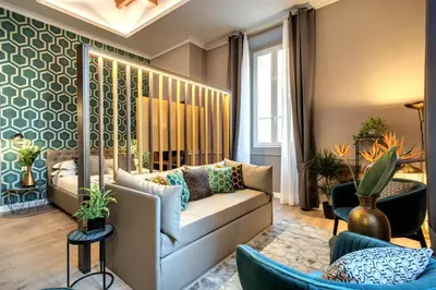 a living room with a couch and chairs at Tree Charme Parliament Boutique Hotel in Rome