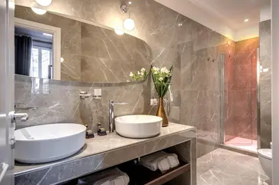 a bathroom with a white sink and a mirror at Tree Charme Parliament Boutique Hotel in Rome