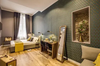 a hotel room with a bed and a mirror at Tree Charme Parliament Boutique Hotel in Rome