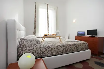 a living room with a bed and a table at Angels In Rome in Rome