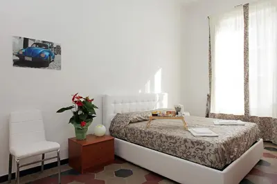 a bedroom with a bed with a table and a chair at Angels In Rome in Rome