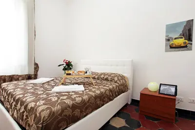 a bedroom with a bed with a table on it at Angels In Rome in Rome