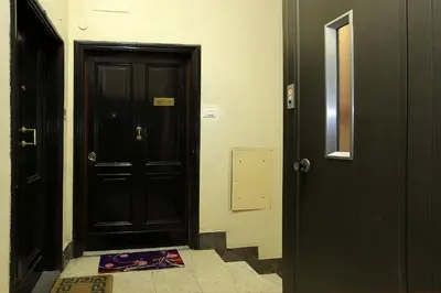 a hallway with a black door and a tile floor at Angels In Rome in Rome