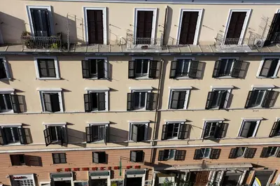 a tall building with windows and balconies on it at Angels In Rome in Rome