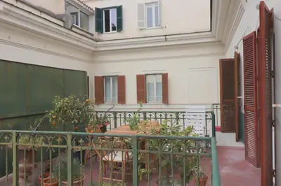 a balcony with a table and some plants at Trevi Suite B&B in Rome