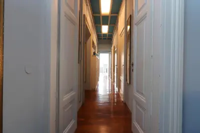 a hallway with white walls and wooden floors at Trevi Suite B&B in Rome