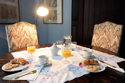 a table with plates of food and glasses of orange juice at Trevi Suite B&B in Rome