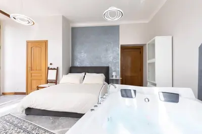 a bedroom with a large bed and a large mirror at jacuzzi in front of the colosseum in Rome