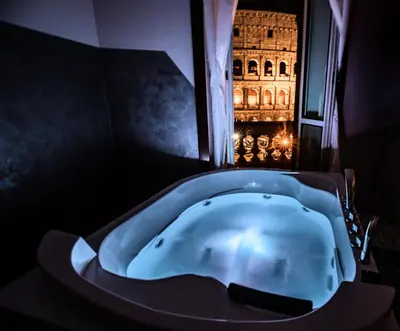 a bath tub in a room with a building at jacuzzi in front of the colosseum in Rome