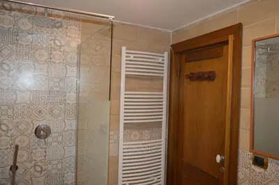 a bathroom with a shower with a glass door at Balcony Colosseum View in Rome