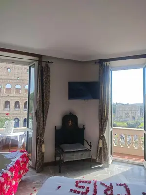 a bedroom with a bed and a large window at View Colosseo From Jacuzzi in Rome