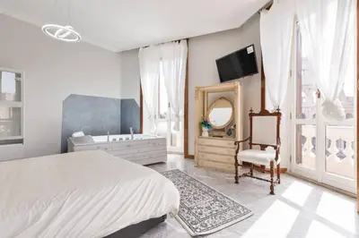 a bedroom with a bed and a tub and a mirror at View Colosseo From Jacuzzi in Rome