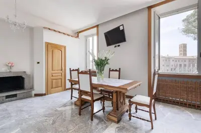 a dining room with a table and chairs and a fireplace at View Colosseo From Jacuzzi in Rome