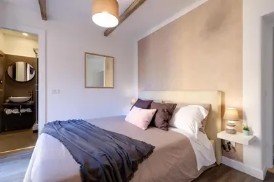 a bedroom with a large bed with white sheets and pillows at Domus De Fiori in Rome