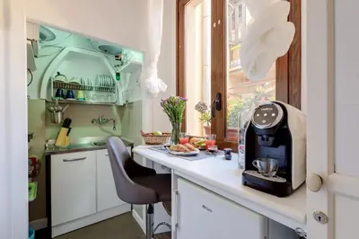 a kitchen with a counter with a coffee maker on it at Domus De Fiori in Rome