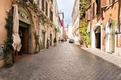 an empty street in a city with buildings at Domus De Fiori in Rome