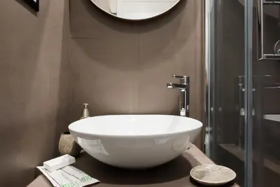 a bathroom with a large white bowl sink on a counter at Domus De Fiori in Rome