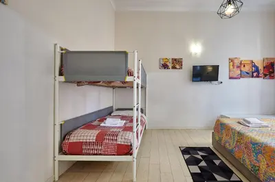 a room with two bunk beds and a tv at Casa al Viminale in Rome