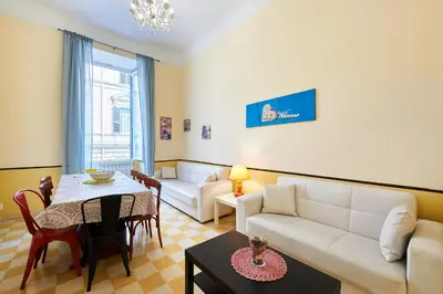 a living room with a white couch and a table at Casa al Viminale in Rome