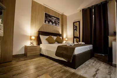 a bedroom with a bed with two candles on it at Noemi's Rooms Guest House in Rome