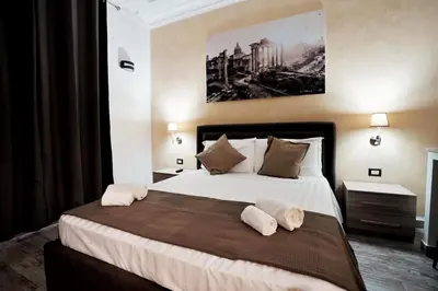 a bedroom with a large bed with two pillows at Noemi's Rooms Guest House in Rome