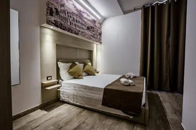 a bedroom with a bed and a table in it at Noemi's Rooms Guest House in Rome