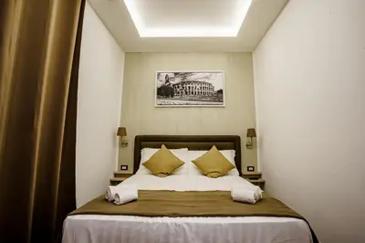 a bedroom with a large bed with yellow pillows at Noemi's Rooms Guest House in Rome