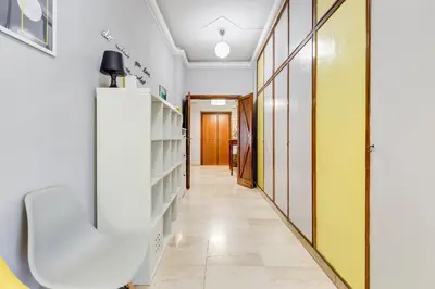 a hallway with yellow and white doors and a white shelf at BDC - King Termini Apartment in Rome
