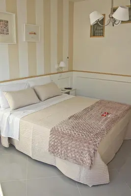 a bedroom with a large bed in a room at Glamroom Vatican Apartment in Rome